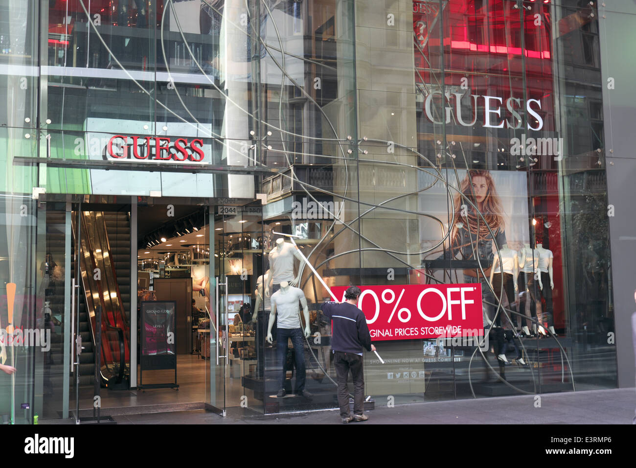 man cleaning the windows of the Guess retail store in Sydney's pitt street, australia Stock Photo - Alamy
