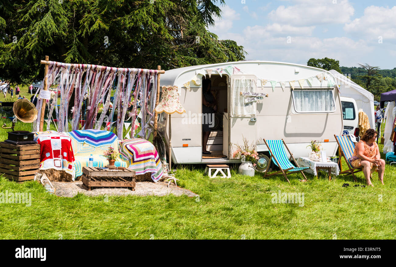 East Devon, England. A woman sits on a deck chair outside her old vintage  caravan at a Fete at a country house Stock Photo - Alamy