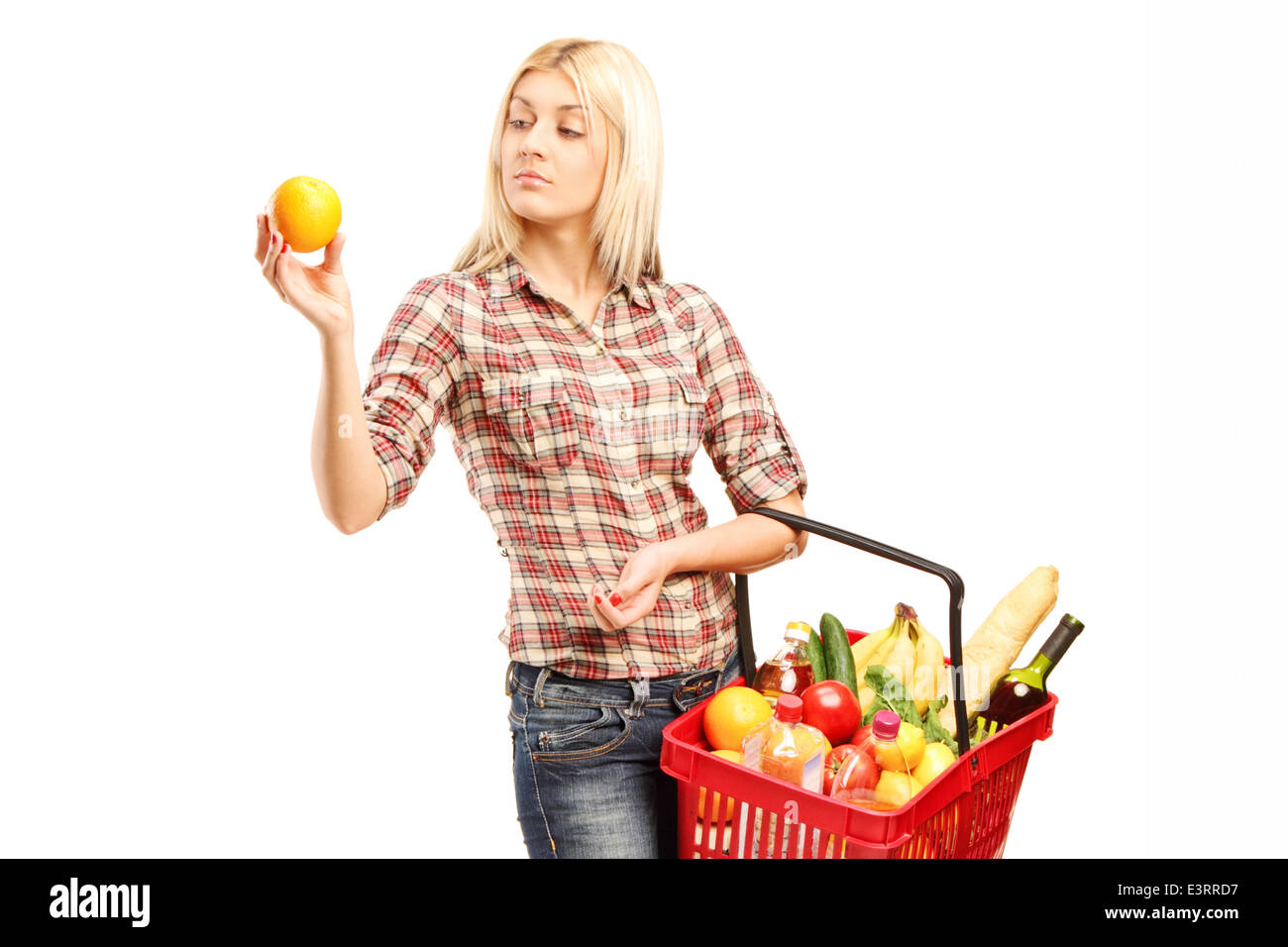 Young woman holding a basket full of groceries Stock Photo - Alamy