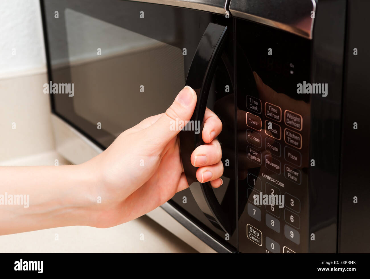 Hand opens microwave Stock Photo Alamy