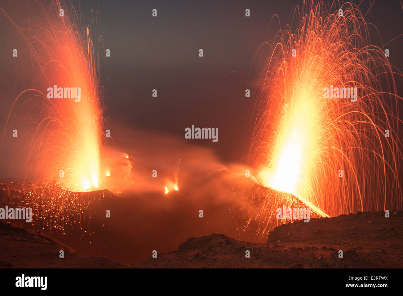 Volcanic eruption at Stromboli volcano, Eolian Islands: strombolian eruptions and lava fountains from the active crater at night Stock Photo