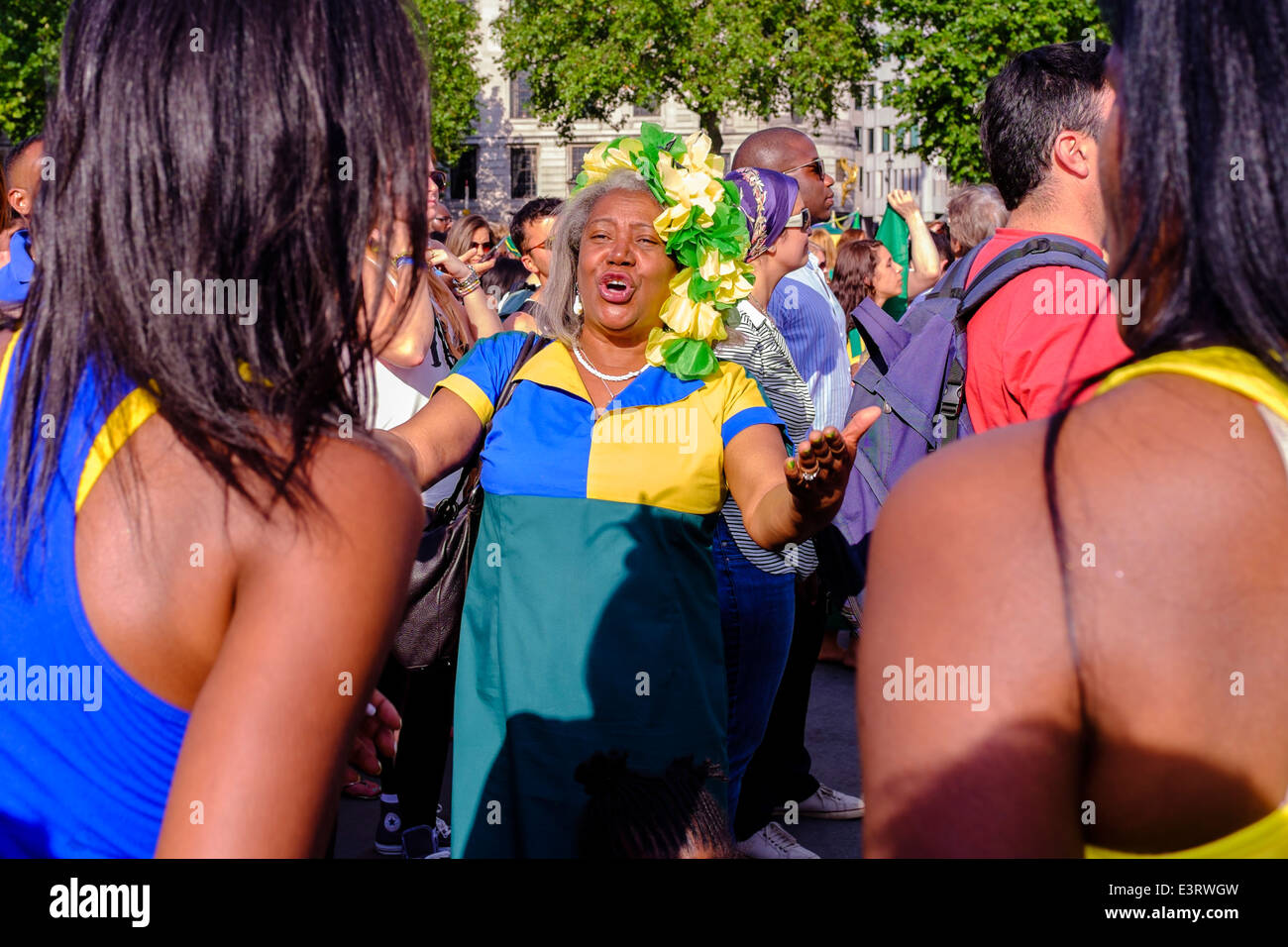 A mature Afro-Caribbean woman dancing during Brazil Day Festival, Trafalgar Square. London, UK Stock Photo