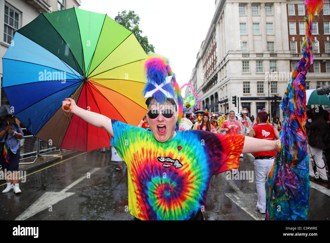 London, UK. 28th June 2014. Pride London 2014, London, England. Rain storms throughout the day didn't dampen the spirits of the 20,000 people in the parade of the crowds in the packed streets watching. It did however bring out plenty of rainbow umbrellas. Credit:  Paul Brown/Alamy Live News Stock Photo