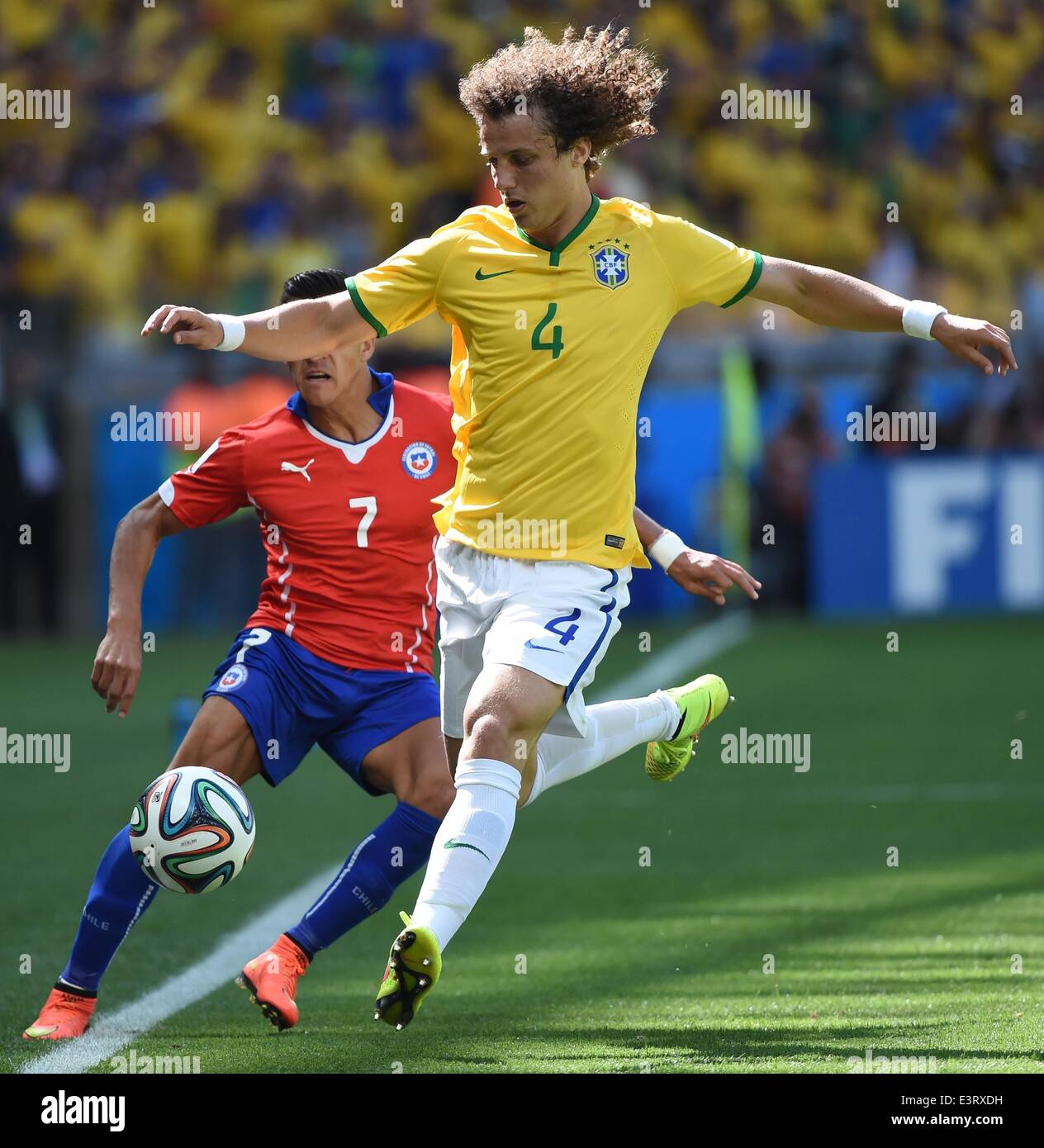Belo Horizonte, Brazil. 28th June, 2014. Brazil's David Luiz vies with Chile's Alexis Sanchez during a Round of 16 match between Brazil and Chile of 2014 FIFA World Cup at the Estadio Mineirao Stadium in Belo Horizonte, Brazil, on June 28, 2014. Credit:  Liu Dawei/Xinhua/Alamy Live News Stock Photo