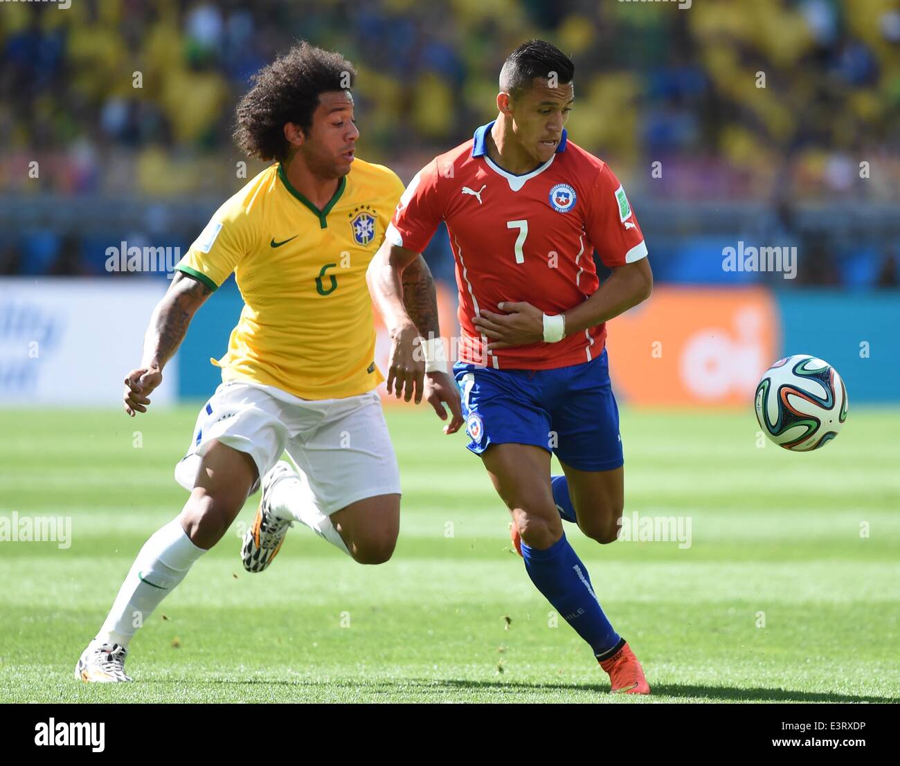 Belo Horizonte, Brazil. 28th June, 2014. Brazil's Marcelo vies with Chile's Alexis Sanchez during a Round of 16 match between Brazil and Chile of 2014 FIFA World Cup at the Estadio Mineirao Stadium in Belo Horizonte, Brazil, on June 28, 2014. Credit:  Liu Dawei/Xinhua/Alamy Live News Stock Photo