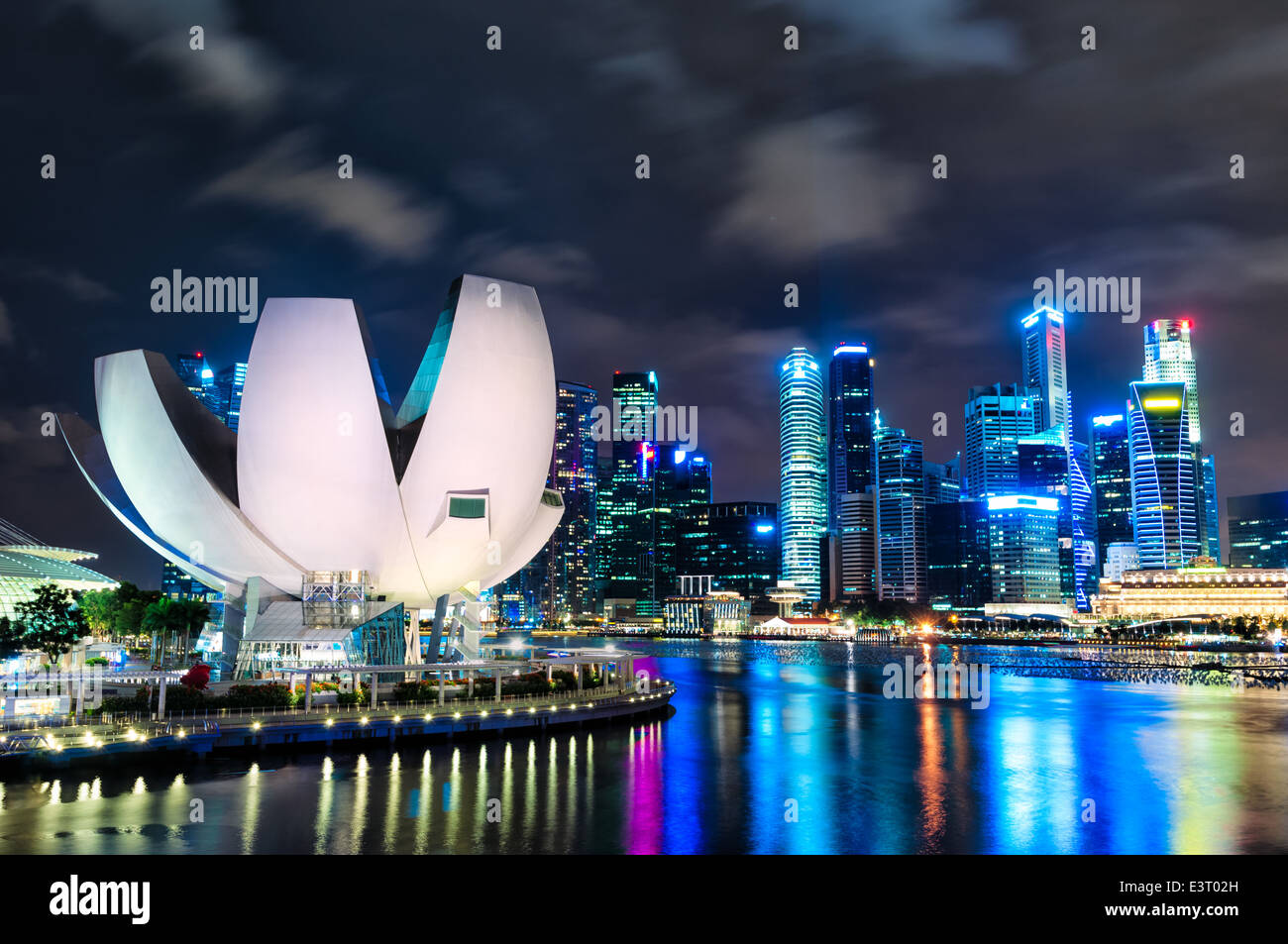 The Singapore skyline at night with the ArtScience museum in the foreground. Stock Photo