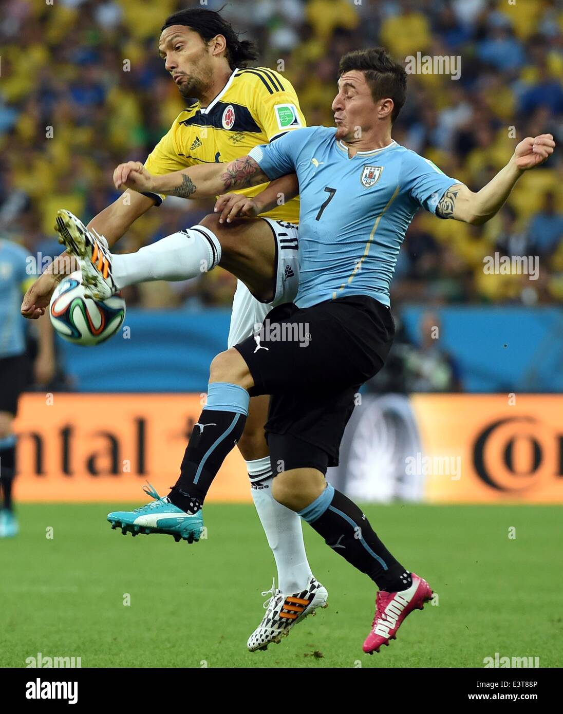 Rio De Janeiro, Brazil. 28th June, 2014. Colombia's Abel Aguilar vies with Uruguay's Cristian Rodriguez during a Round of 16 match between Colombia and Uruguay of 2014 FIFA World Cup at the Estadio do Maracana Stadium in Rio de Janeiro, Brazil, on June 28, 2014. Credit:  Wang Yuguo/Xinhua/Alamy Live News Stock Photo