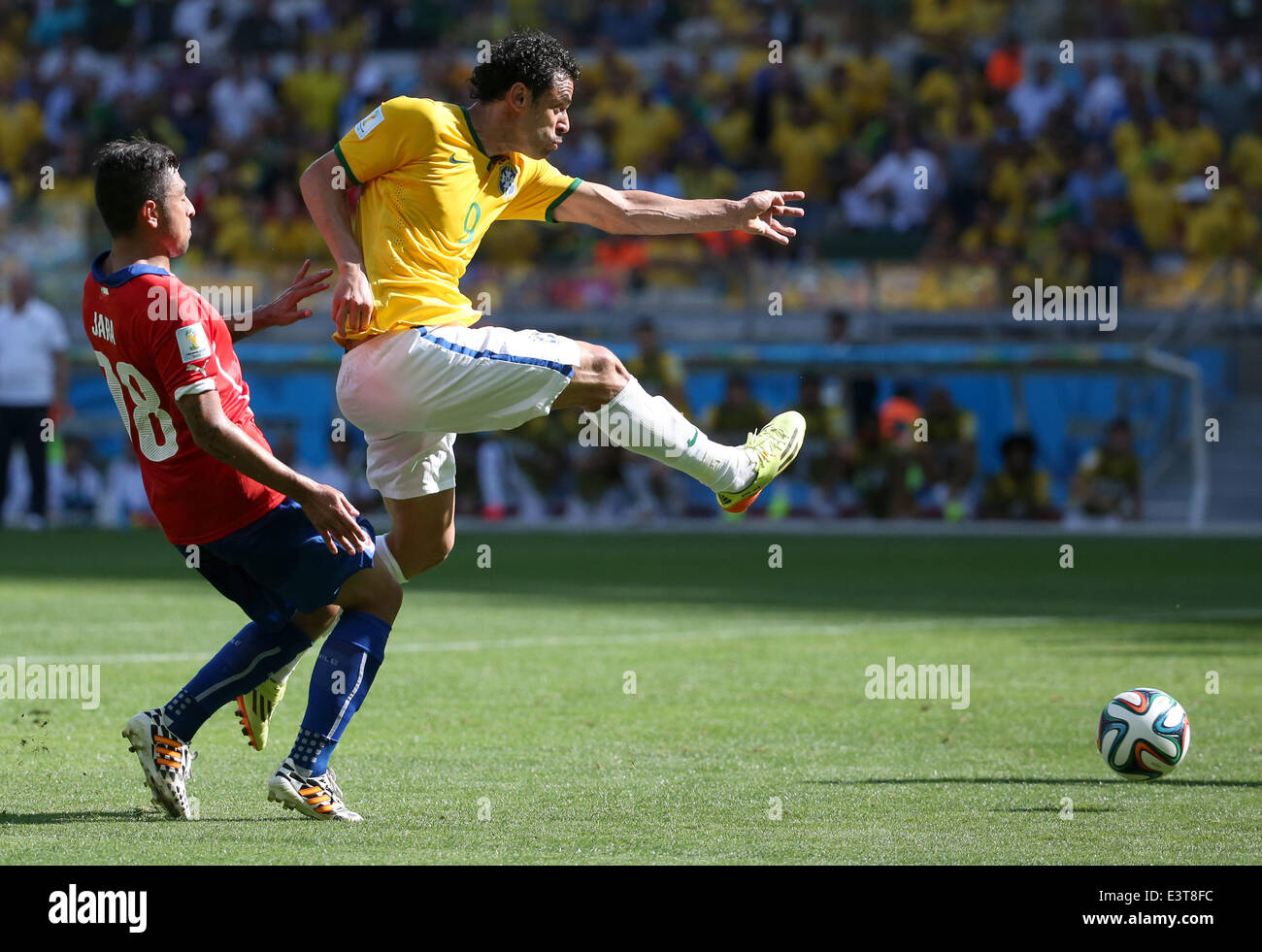 Belo Horizonte, Brazil. 28th June, 2014. Brazil's Fred vies with Chile's Gonzalo Jara during a Round of 16 match between Brazil and Chile of 2014 FIFA World Cup at the Estadio Mineirao Stadium in Belo Horizonte, Brazil, on June 28, 2014. Credit:  Li Ming/Xinhua/Alamy Live News Stock Photo