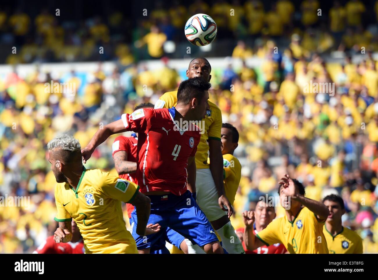 Belo Horizonte, Brazil. 28th June, 2014. Brazil's Fernandinho competes for a header with Chile's Mauricio Isla during a Round of 16 match between Brazil and Chile of 2014 FIFA World Cup at the Estadio Mineirao Stadium in Belo Horizonte, Brazil, on June 28, 2014. Credit:  Liu Dawei/Xinhua/Alamy Live News Stock Photo