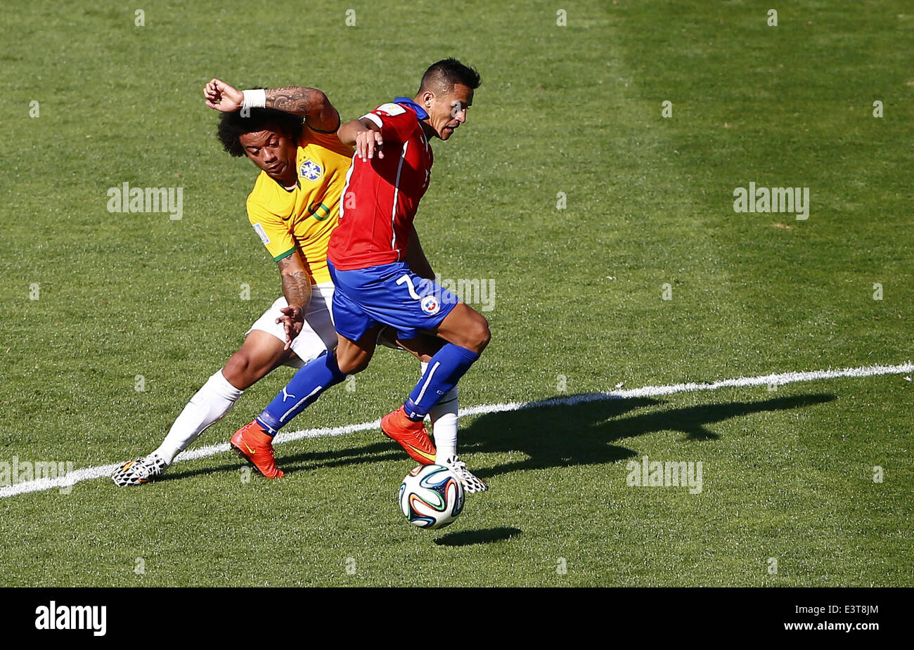 Belo Horizonte, Brazil. 28th June, 2014. Brazil's Marcelo (L) vies with Chile's Alexis Sanchez during a Round of 16 match between Brazil and Chile of 2014 FIFA World Cup at the Estadio Mineirao Stadium in Belo Horizonte, Brazil, on June 28, 2014. Credit:  Liu Bin/Xinhua/Alamy Live News Stock Photo