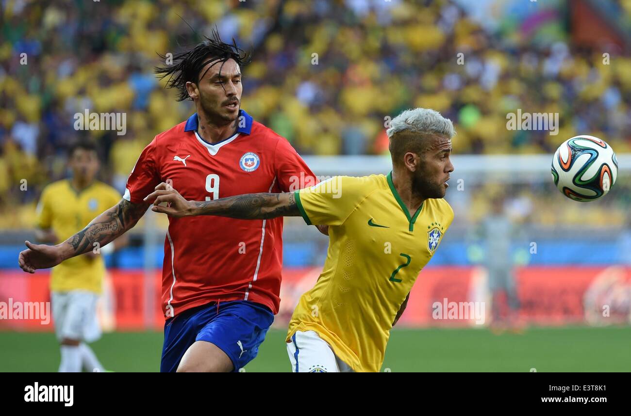 Belo Horizonte, Brazil. 28th June, 2014. Brazil's Dani Alves vies with Chile's Mauricio Pinilla during a Round of 16 match between Brazil and Chile of 2014 FIFA World Cup at the Estadio Mineirao Stadium in Belo Horizonte, Brazil, on June 28, 2014. Credit:  Liu Dawei/Xinhua/Alamy Live News Stock Photo
