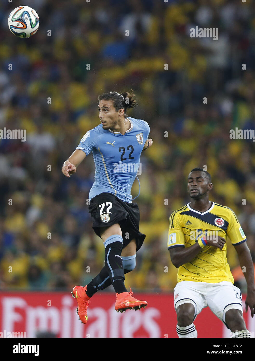 Rio De Janeiro, Brazil. 28th June, 2014. Uruguay's Martin Caceres (L) heads the ball during a Round of 16 match between Colombia and Uruguay of 2014 FIFA World Cup at the Estadio do Maracana Stadium in Rio de Janeiro, Brazil, on June 28, 2014. Credit:  Wang Lili/Xinhua/Alamy Live News Stock Photo