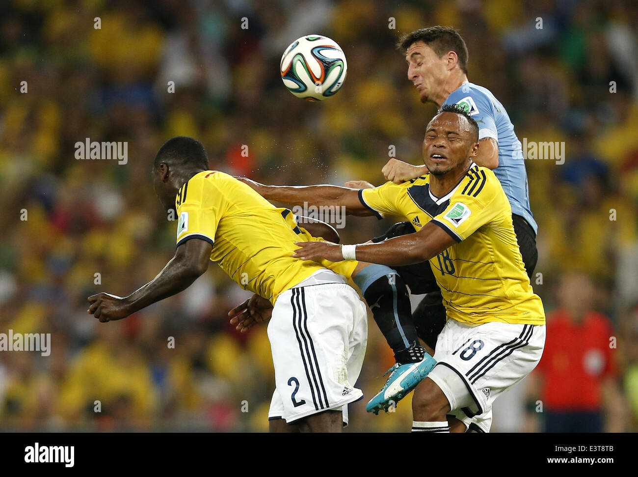 Rio De Janeiro, Brazil. 28th June, 2014. Uruguay's Cristian Rodriguez (back) competes for a header with Colombia's Cristian Zapata (L, front) and Juan Zuniga during a Round of 16 match between Colombia and Uruguay of 2014 FIFA World Cup at the Estadio do Maracana Stadium in Rio de Janeiro, Brazil, on June 28, 2014. Credit:  Wang Lili/Xinhua/Alamy Live News Stock Photo