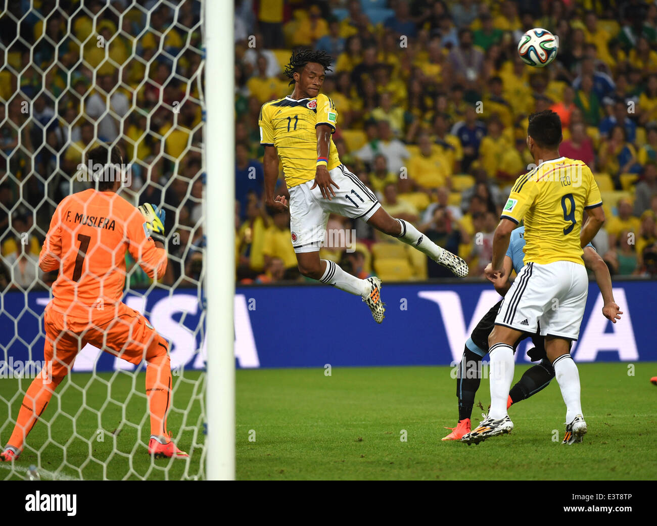 Rio De Janeiro, Brazil. 28th June, 2014. Colombia's Juan Guillermo Cuadrado (2nd L) jumps for the ball during a Round of 16 match between Colombia and Uruguay of 2014 FIFA World Cup at the Estadio do Maracana Stadium in Rio de Janeiro, Brazil, on June 28, 2014. Colombia won 2-0 over Uruguay on Saturday. Credit:  Wang Yuguo/Xinhua/Alamy Live News Stock Photo