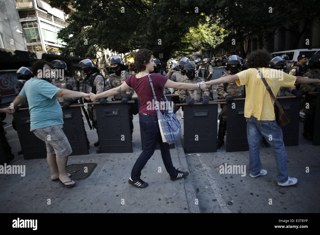 Belo Horizonte, Brazil. 28th June, 2014. Demonstrators walk hand in hand past riot police during a protest against FIFA World Cup in Sao Paulo, Brazil, on June 28, 2014. Credit:  Mauricio Valenzuela/Xinhua/Alamy Live News Stock Photo