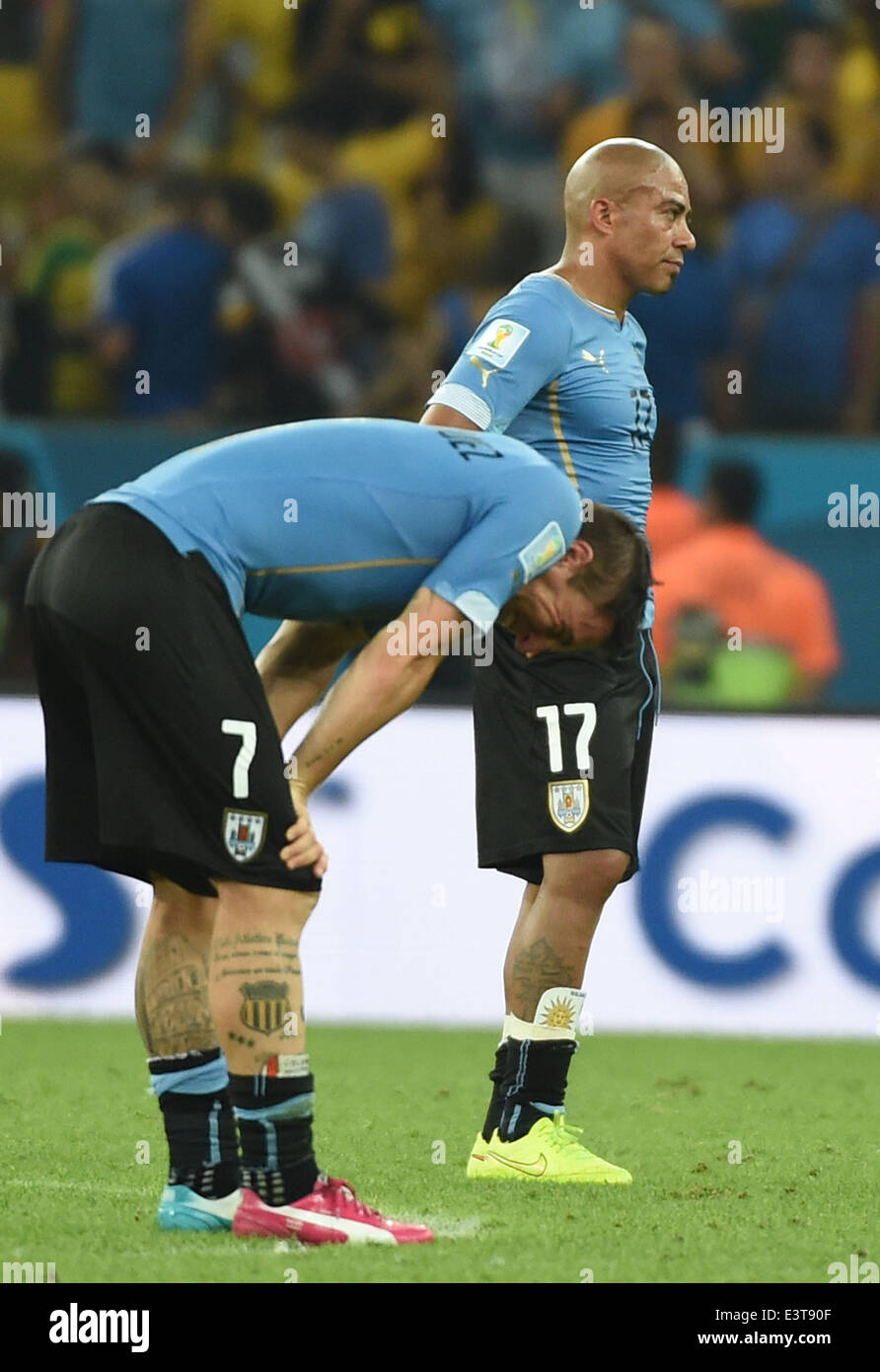 Rio De Janeiro, Brazil. 28th June, 2014. Uruguay's Egidio Arevalo Rios (R) and Cristian Rodriguez react after a Round of 16 match between Colombia and Uruguay of 2014 FIFA World Cup at the Estadio do Maracana Stadium in Rio de Janeiro, Brazil, on June 28, 2014. Colombia won 2-0 over Uruguay on Saturday. Credit:  Wang Yuguo/Xinhua/Alamy Live News Stock Photo