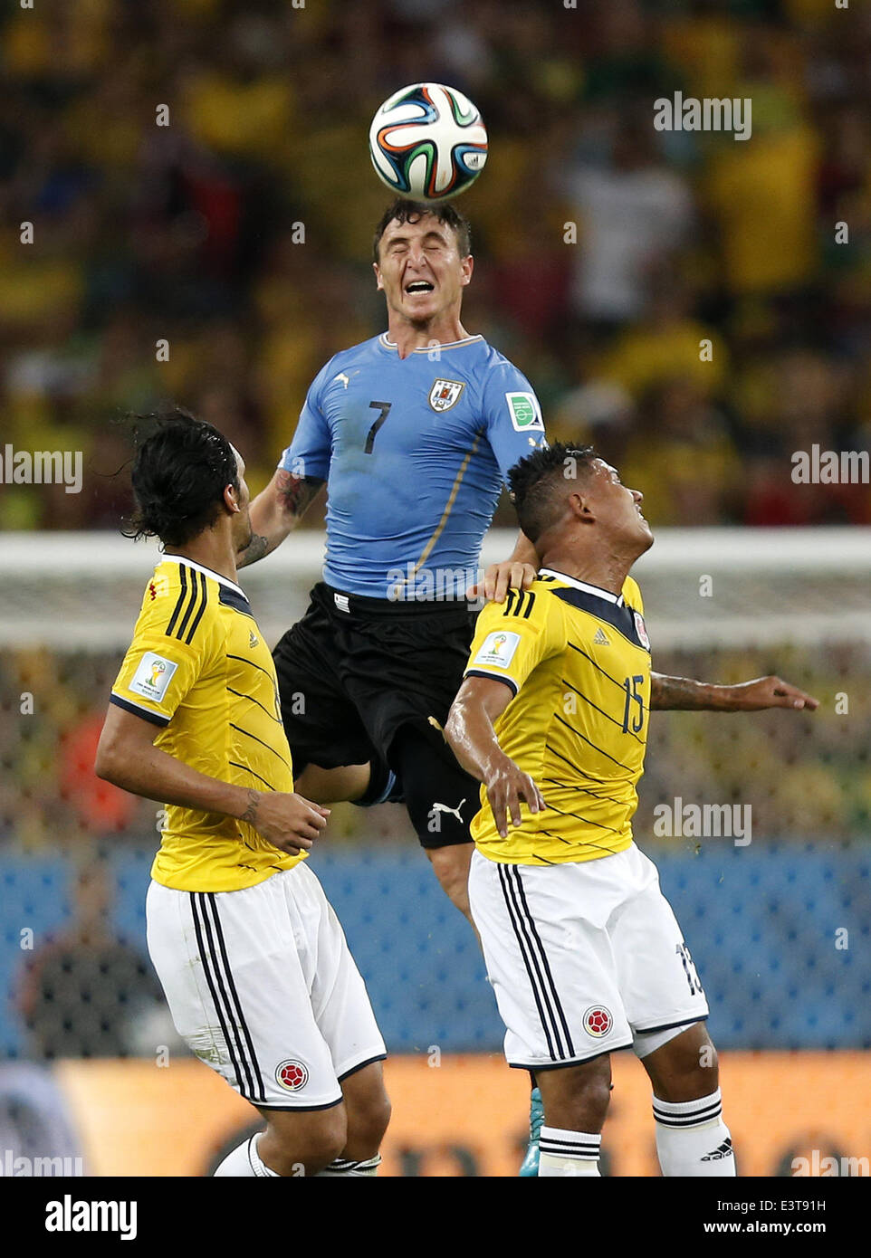 Rio De Janeiro, Brazil. 28th June, 2014. Uruguay's Cristian Rodriguez (C) heads the ball during a Round of 16 match between Colombia and Uruguay of 2014 FIFA World Cup at the Estadio do Maracana Stadium in Rio de Janeiro, Brazil, on June 28, 2014. Colombia won 2-0 over Uruguay and qualified for Quarter-finals on Saturday. Credit:  Wang Lili/Xinhua/Alamy Live News Stock Photo