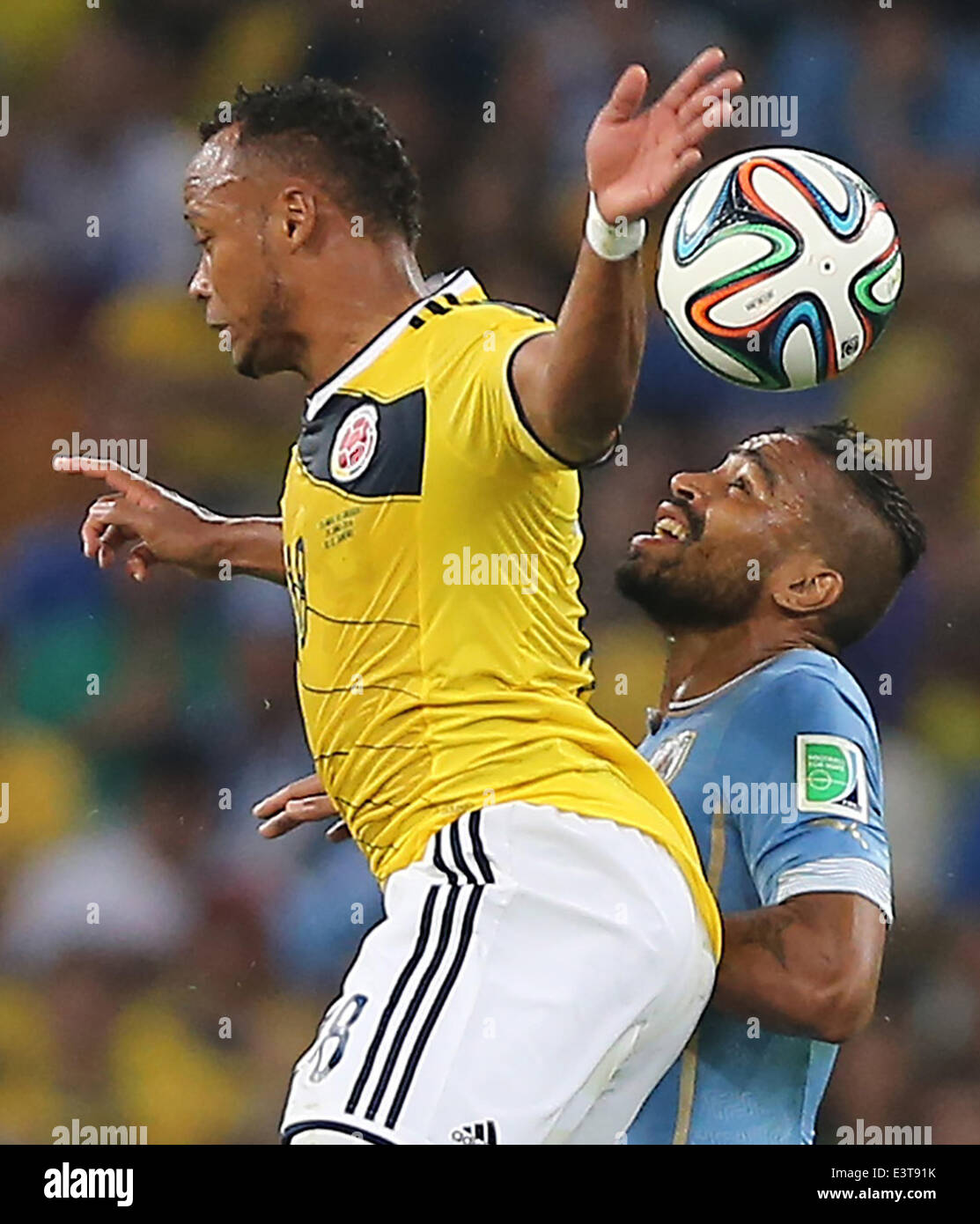 Rio De Janeiro, Brazil. 28th June, 2014. Colombia's Juan Zuniga jumps for the ball during a Round of 16 match between Colombia and Uruguay of 2014 FIFA World Cup at the Estadio do Maracana Stadium in Rio de Janeiro, Brazil, on June 28, 2014. Colombia won 2-0 over Uruguay on Saturday. Credit:  Xu Zijian/Xinhua/Alamy Live News Stock Photo