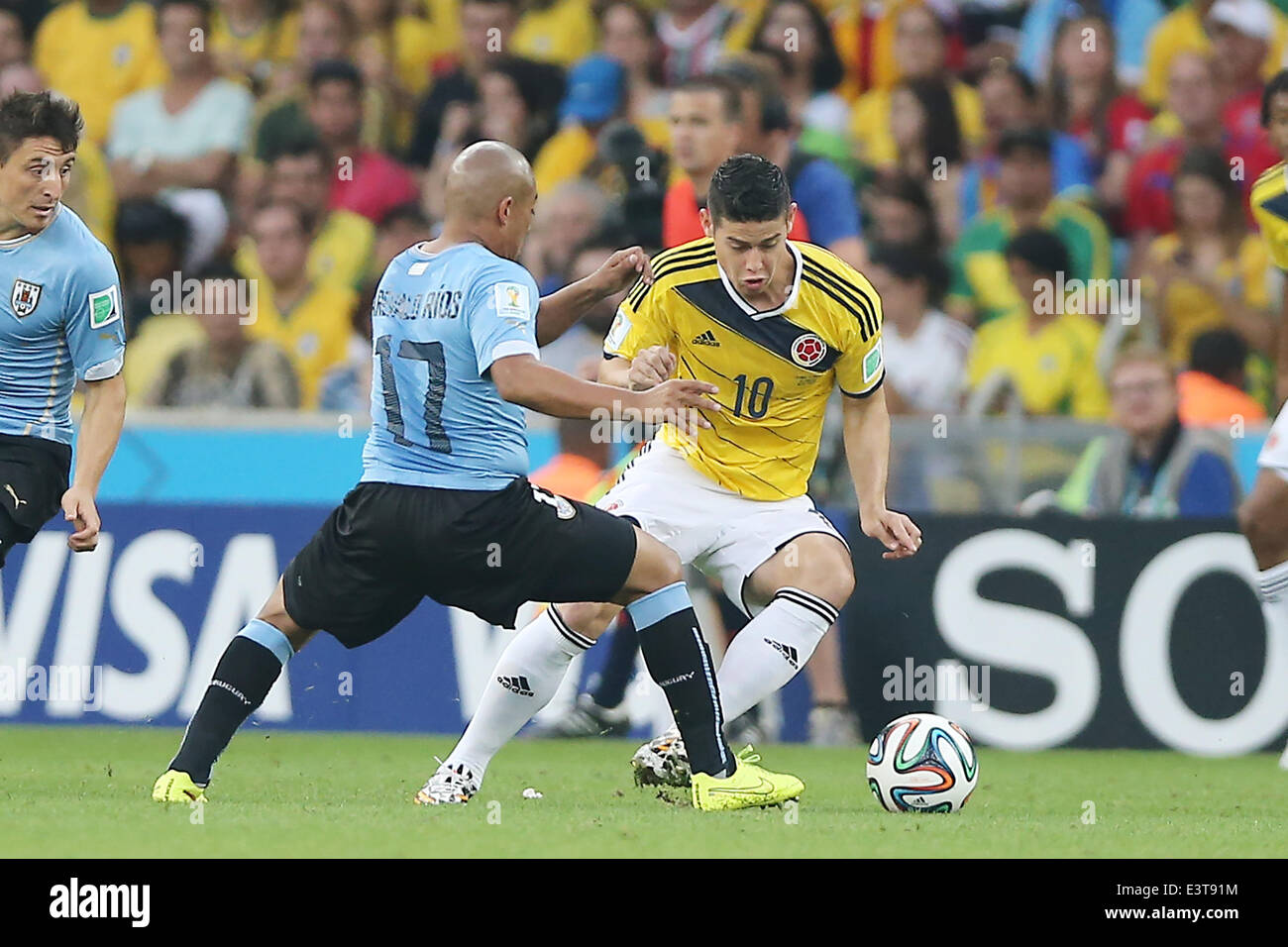Rio De Janeiro, Brazil. 28th June, 2014. Colombia's James Rodriguez vies with Uruguay's Egidio Arevalo Rios during a Round of 16 match between Colombia and Uruguay of 2014 FIFA World Cup at the Estadio do Maracana Stadium in Rio de Janeiro, Brazil, on June 28, 2014. Colombia won 2-0 over Uruguay on Saturday. Credit:  Xu Zijian/Xinhua/Alamy Live News Stock Photo