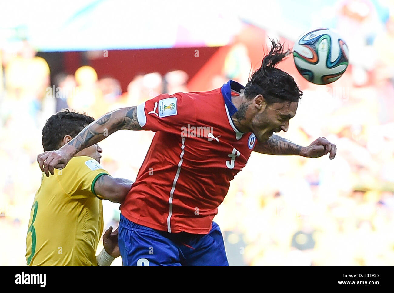 Belo Horizonte, Brazil. 28th June, 2014. Chile's Mauricio Pinilla (R) heads the ball during a Round of 16 match between Brazil and Chile of 2014 FIFA World Cup at the Estadio Mineirao Stadium in Belo Horizonte, Brazil, on June 28, 2014. Brazil won 4-3 (3-2 in penalties) over Chile and qualified for Quarter-finals on Saturday. Credit:  Qi Heng/Xinhua/Alamy Live News Stock Photo