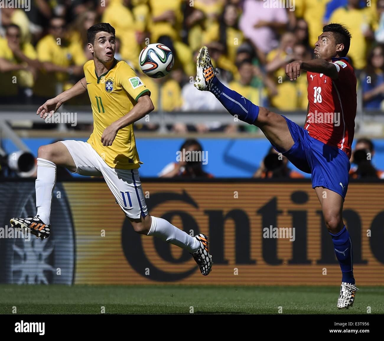 Belo Horizonte, Brazil. 28th June, 2014. Brazil's Oscar (L) vies with Chile's Gonzalo Jara during a Round of 16 match between Brazil and Chile of 2014 FIFA World Cup at the Estadio Mineirao Stadium in Belo Horizonte, Brazil, on June 28, 2014. Credit:  Qi Heng/Xinhua/Alamy Live News Stock Photo