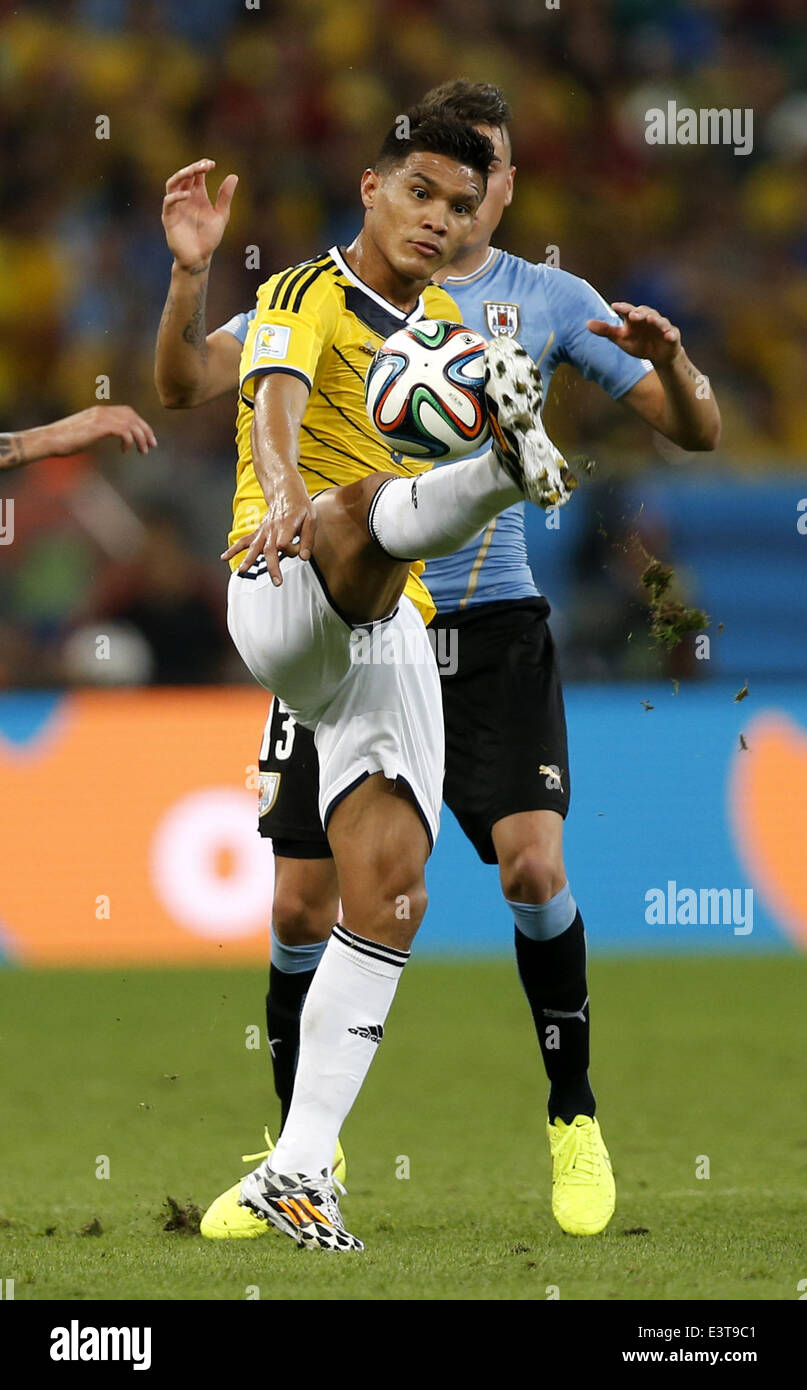 Rio De Janeiro, Brazil. 28th June, 2014. Colombia's Teofilo Gutierrez (front) stops the ball during a Round of 16 match between Colombia and Uruguay of 2014 FIFA World Cup at the Estadio do Maracana Stadium in Rio de Janeiro, Brazil, on June 28, 2014. Colombia won 2-0 over Uruguay and qualified for Quarter-finals on Saturday. Credit:  Wang Lili/Xinhua/Alamy Live News Stock Photo