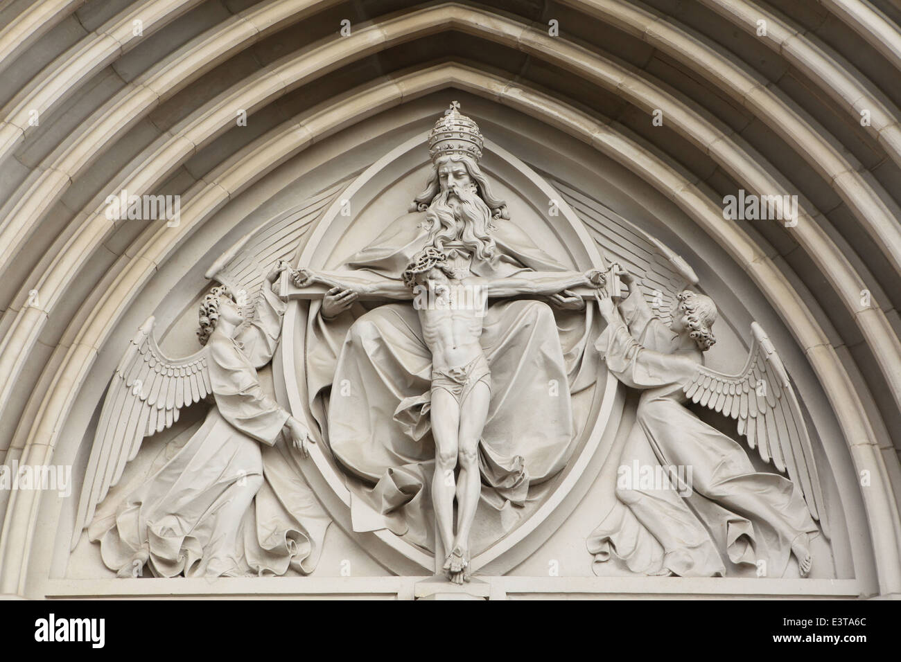 The Holy Trinity. Neo-Gothic relief over the main gate of Saint Wenceslas' Cathedral in Olomouc, Czech Republic. Stock Photo
