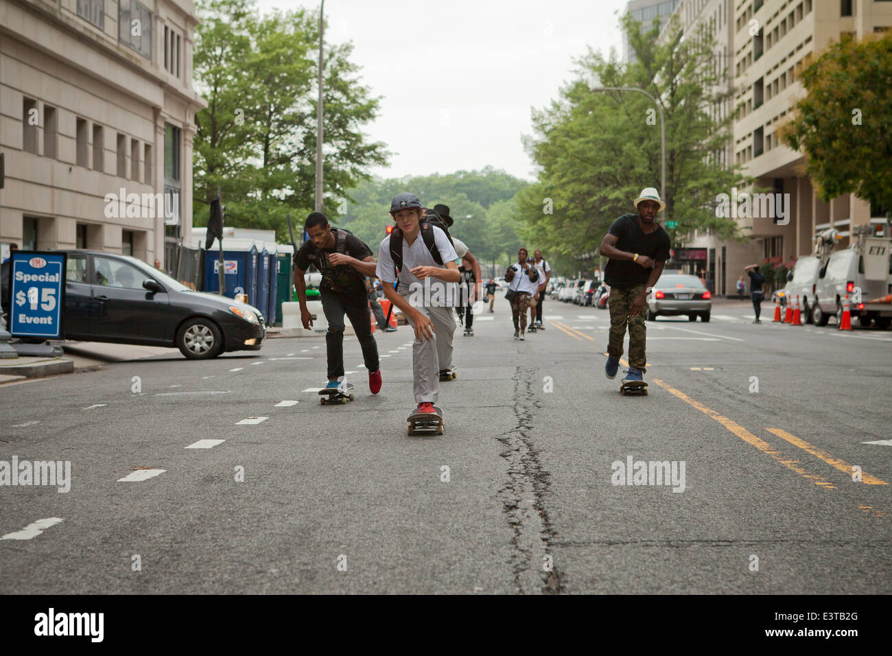 Street skateboarders riding in road - USA Stock Photo