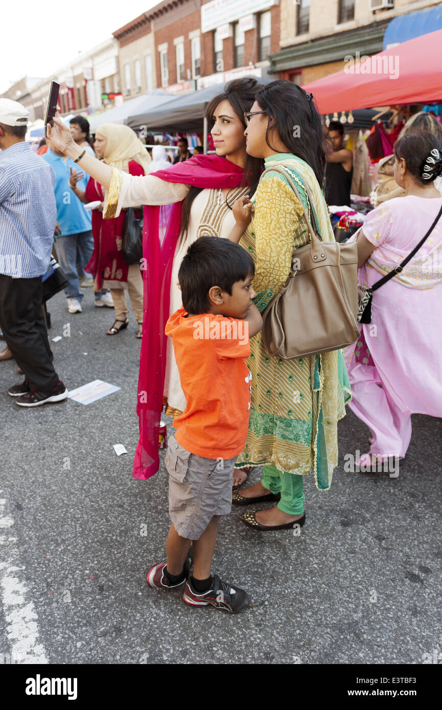 Woman takes a selfie at street fair in 'Little Bangladesh' in the Kensington section of Brooklyn, NY, 2014. Stock Photo