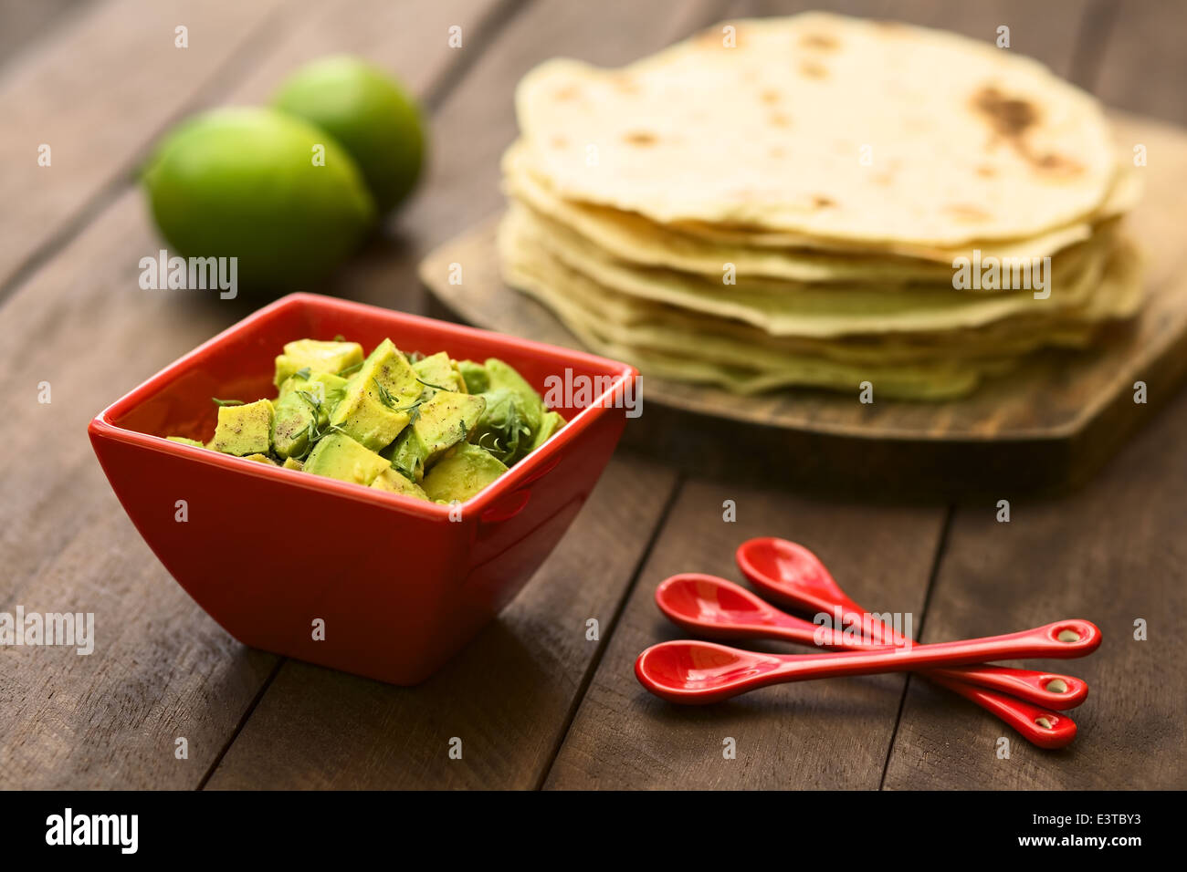 Fresh avocado salad prepared with lime juice, pepper, salt and sprinkled with fresh coriander leaves Stock Photo