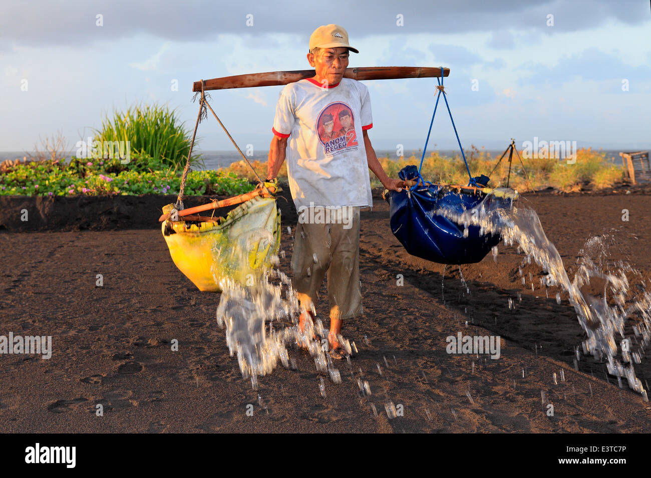One of the few remaining traditional salt makers in Bali, at Kusamba Beach. Bali, Indonesia. Stock Photo