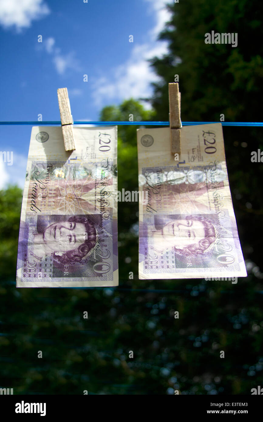 Two British sterling twenty pound notes pegged on a washing line Stock ...