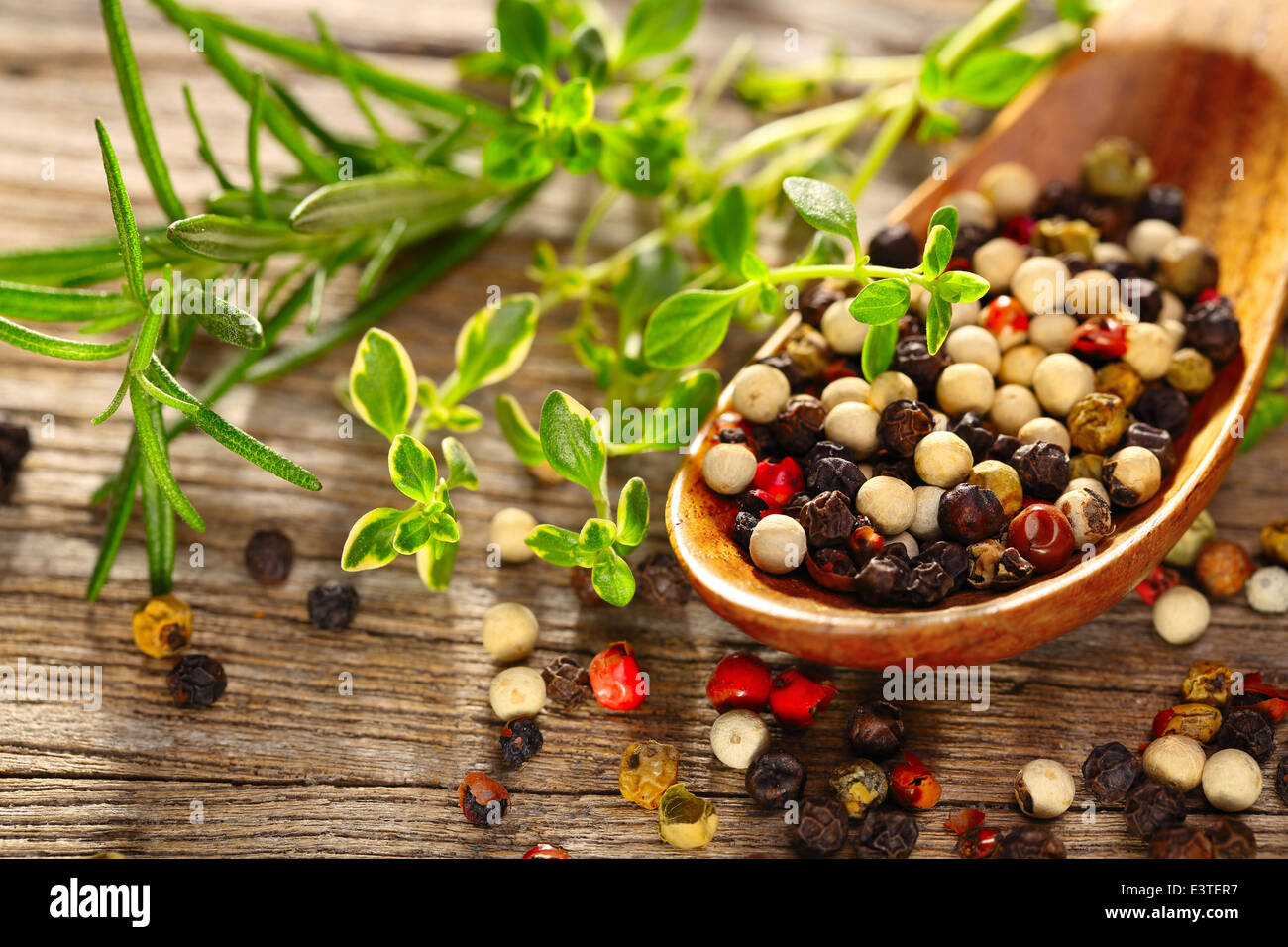 Pepper and thyme on wooden table,Closeup. Stock Photo