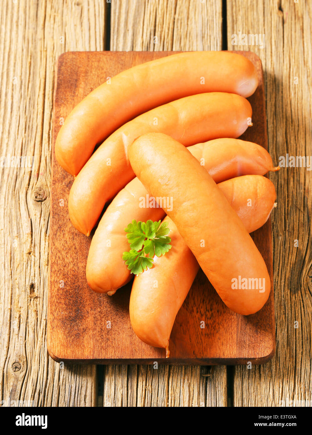 Lean smoked sausages on cutting board Stock Photo