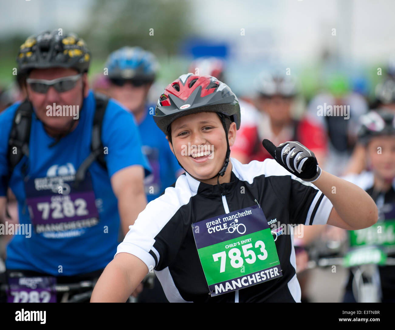 Manchester, UK. 29th June 2014. Thousands of participants take part in the Great Manchester Cycle mass participation cycling event, which takes place each year in the city. The cyclist start at the Etihad City of Manchester Stadium, home of Manchester City Football Club Credit:  Russell Hart/Alamy Live News. Stock Photo