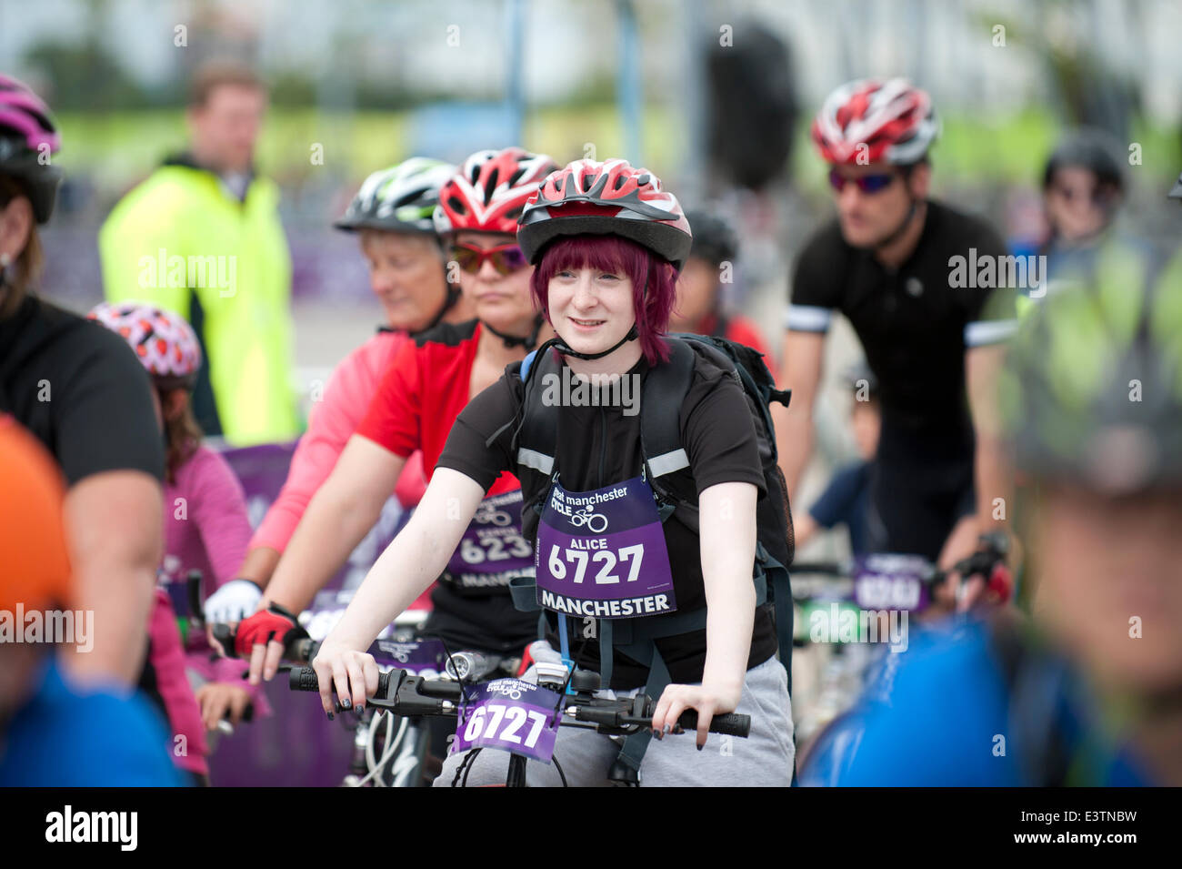 Manchester, UK. 29th June 2014. Thousands of participants take part in the Great Manchester Cycle mass participation cycling event, which takes place each year in the city. The cyclist start at the Etihad City of Manchester Stadium, home of Manchester City Football Club Credit:  Russell Hart/Alamy Live News. Stock Photo