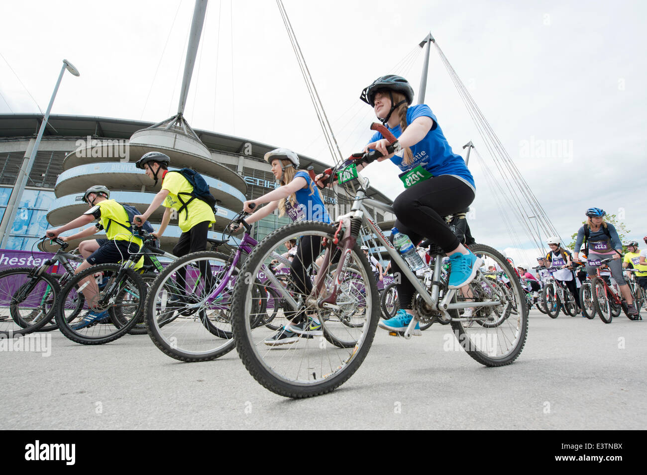 Manchester, UK. 29th June 2014. Thousands of participants take part in the Great Manchester Cycle mass participation cycling event, which takes place each year in the city. The cyclist start at the Etihad City of Manchester Stadium, home of Manchester City Football Club Credit:  Russell Hart/Alamy Live News. Stock Photo