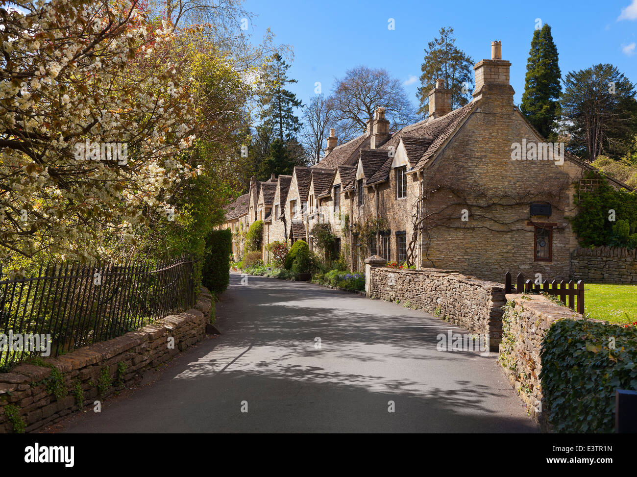 Castle Combe, Wiltshire, general street view of Cotswold stone cottages, bright sun Stock Photo