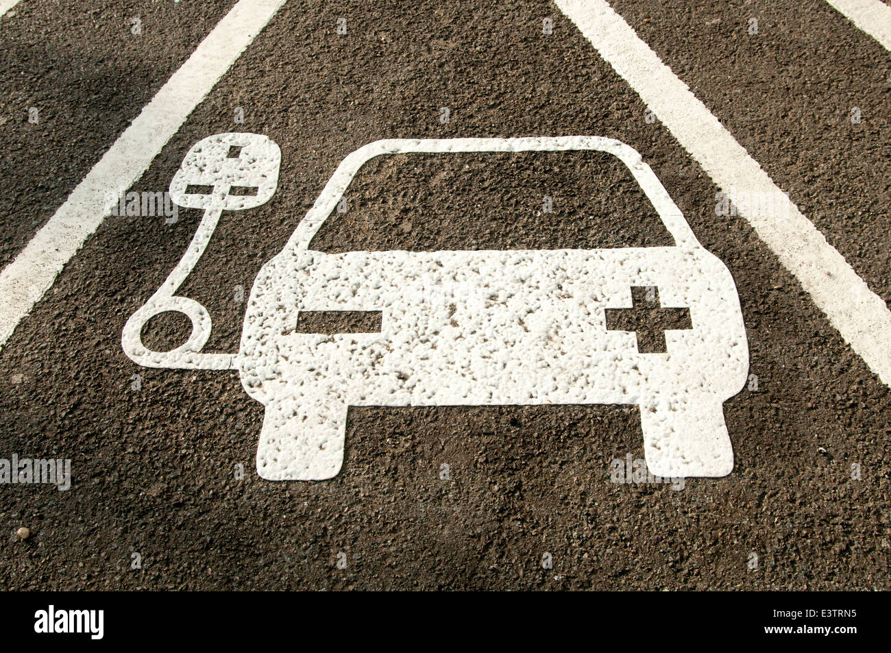 electric vehicle recharging point sign painted on the road Stock Photo