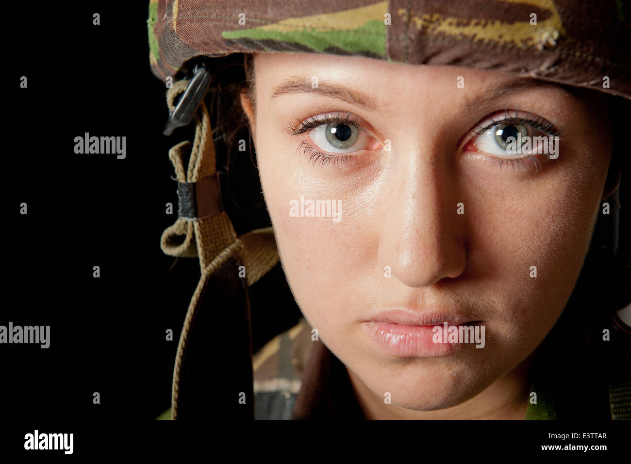 Close up portrait, of a British female soldier, against a black background. Stock Photo