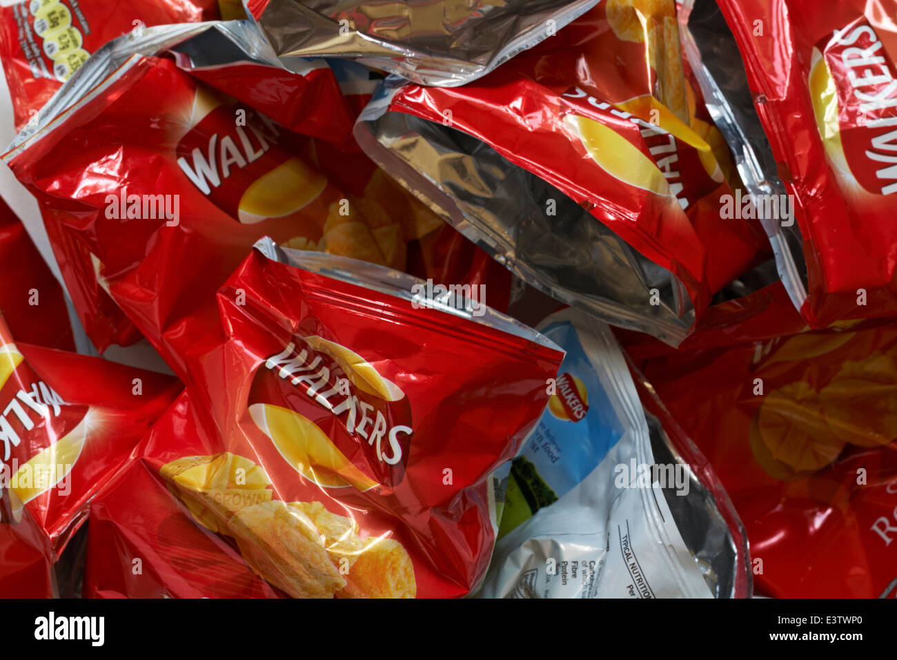 pile heap of empty packets of Walkers Ready Salted crisps Stock Photo