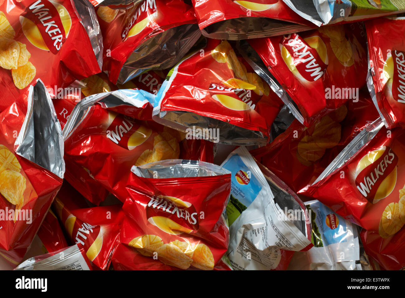 pile heap of empty packet of Walkers Ready Salted crisps Stock Photo