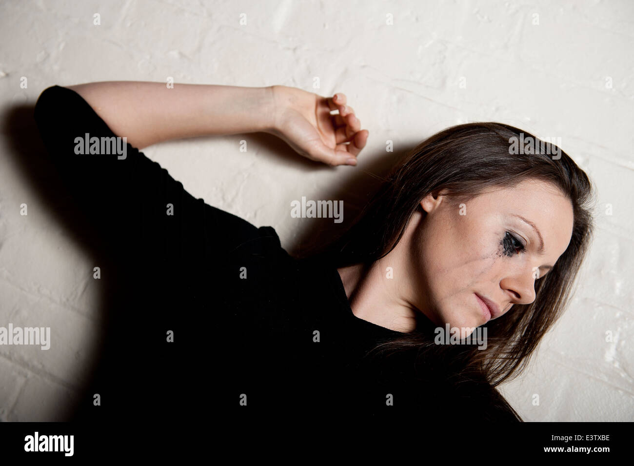 Tearful young woman with her make-up running down her face. Stock Photo