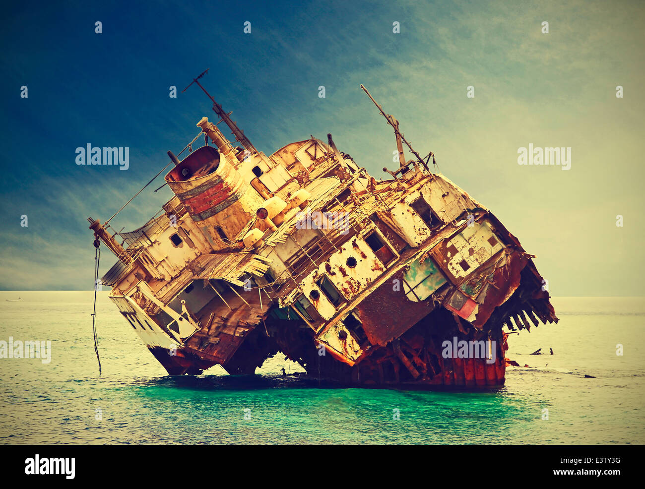 The sunken shipwreck on the reef, Egypt, vintage retro filtered. Stock Photo
