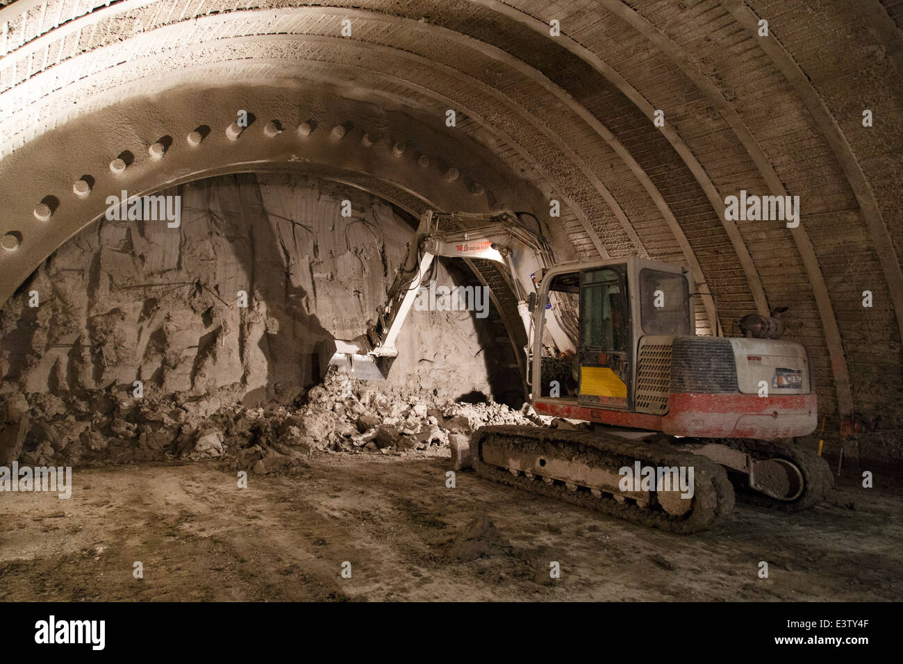 An excavator digging the front of a tunnel Stock Photo Alamy