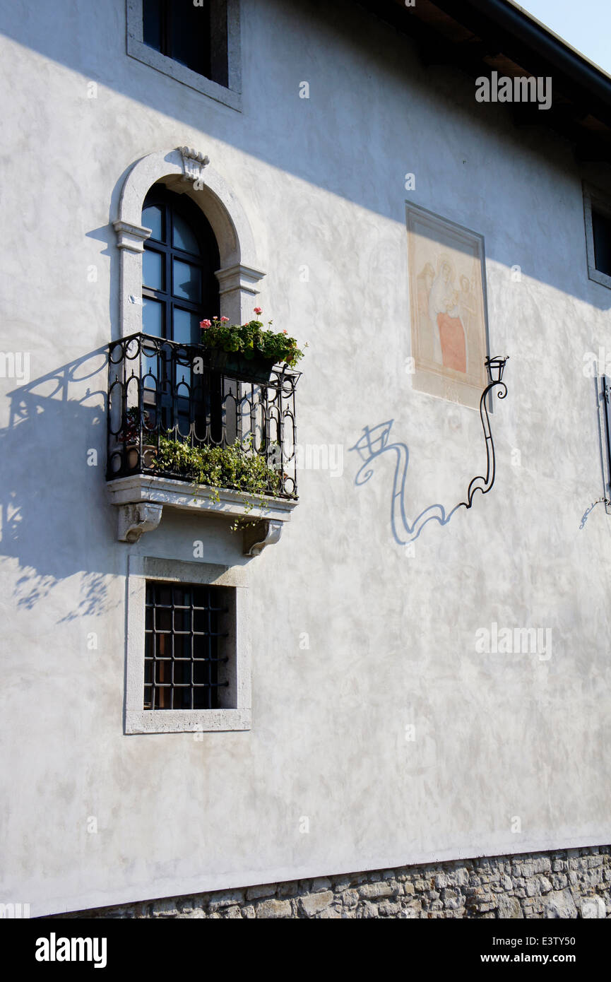 Balcony and lamp cast shadows in the late afternoon light at Aquileia, northern Italy Stock Photo