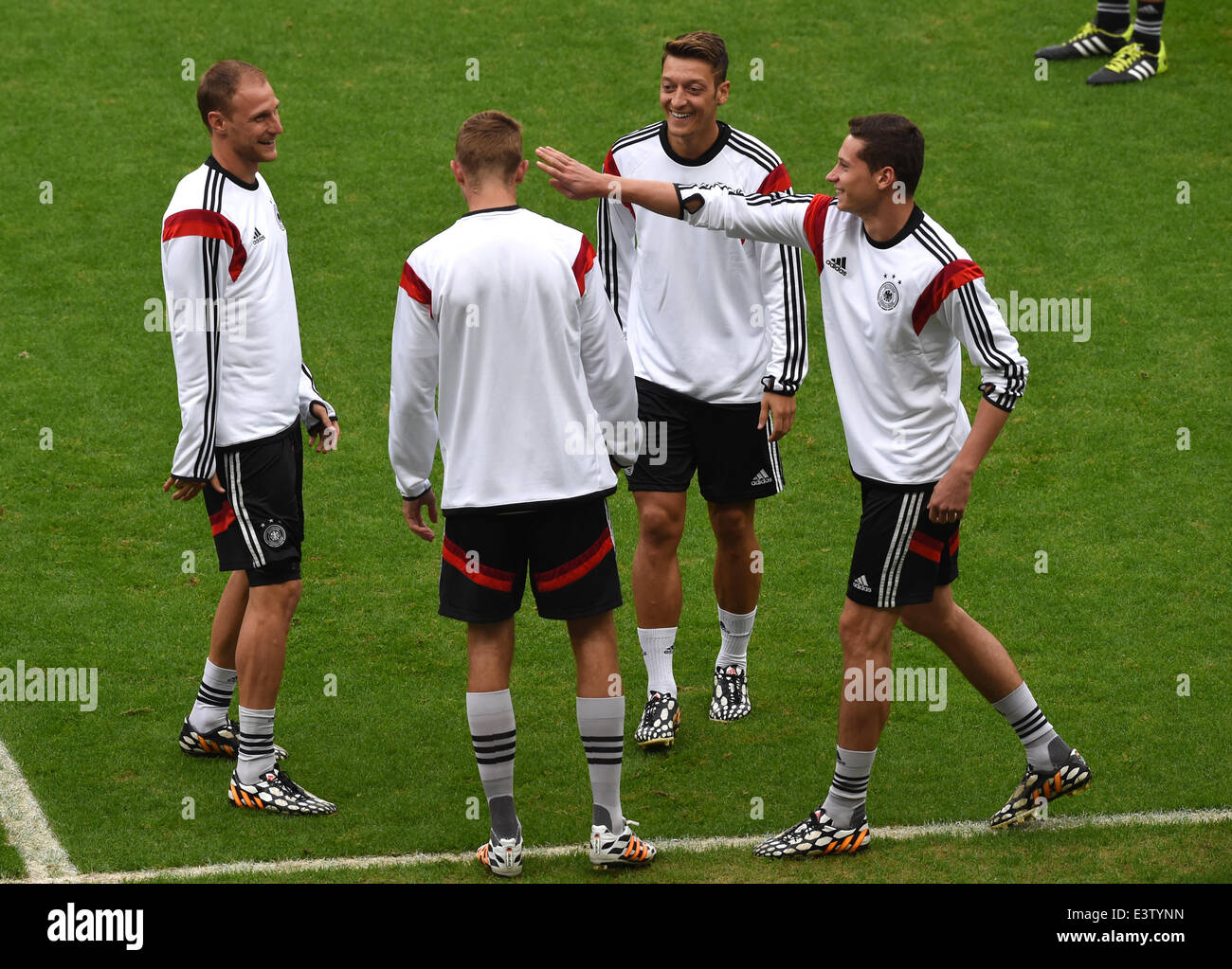 Porto Alegre, Brazil. 29th June, 2014. Germany's (L-R) Benedikt Hoewedes, Christoph Kramer, Mesut Oezil and Julian Draxler fool around during a training session at the Estadio Beira-Rio in Porto Alegre, Brazil, 29 June 2014. Germany faces Algeria in a FIFA soccer World Cup round of sixteen match on 30 June 2014. Photo: Marcus Brandt/dpa/Alamy Live News Stock Photo
