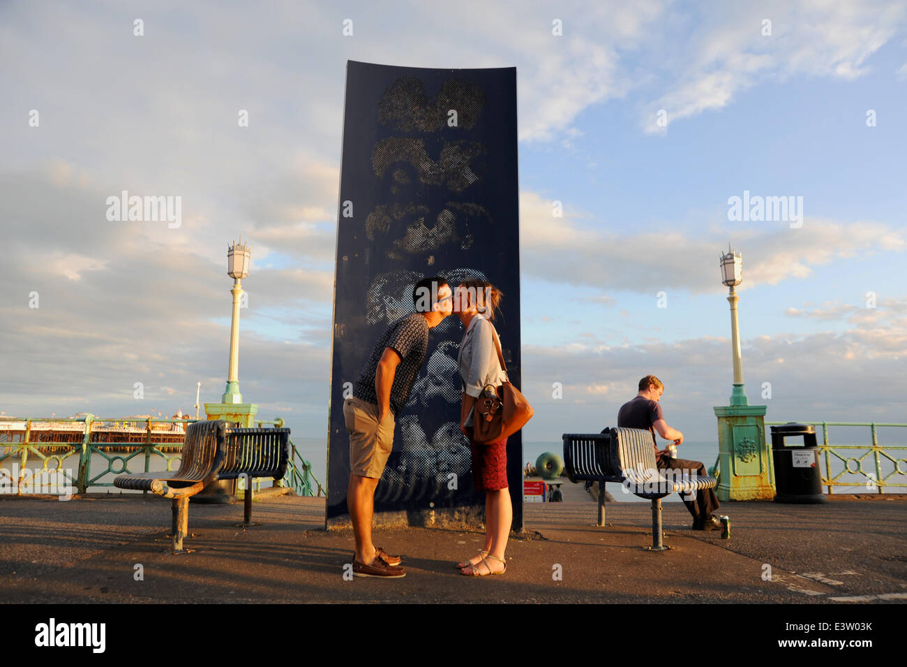 Brighton, Sussex, UK. 29th June, 2014. A couple steal a kiss by the