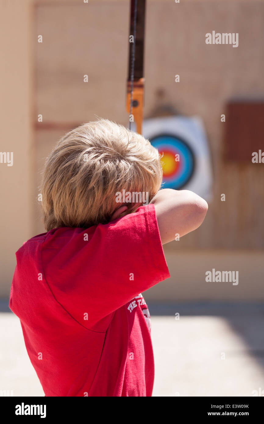 Young boy having a go at archery. (age 8) Stock Photo