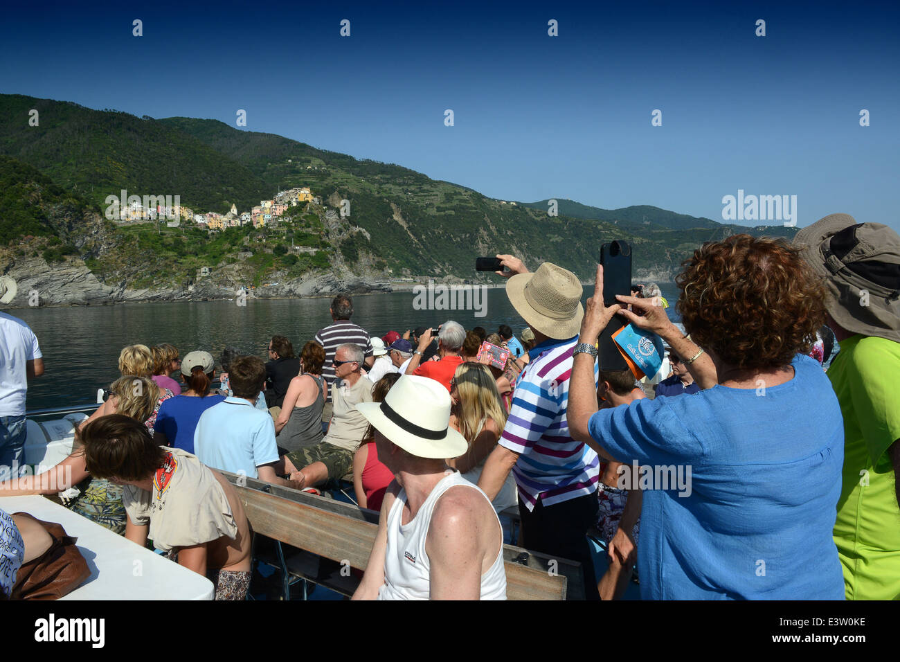 Tourists boat passengers viewing Cinque Terre in Italy Stock Photo